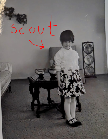 little girl with very short hair in a flowery skirt.